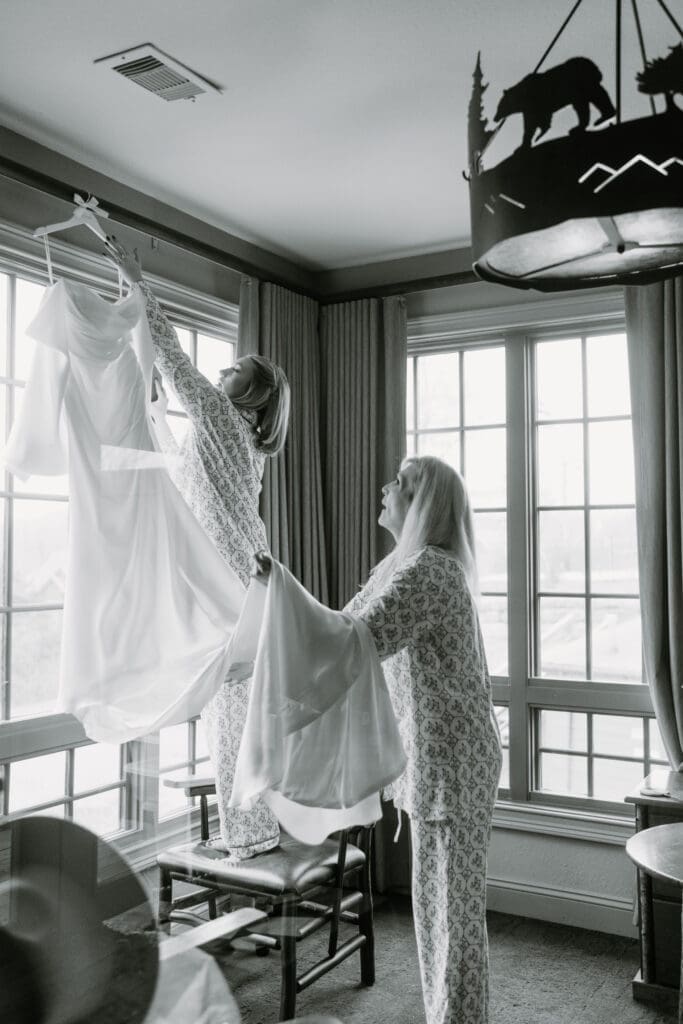 bride hanging up her wedding dress while getting ready at big cedar lodge
