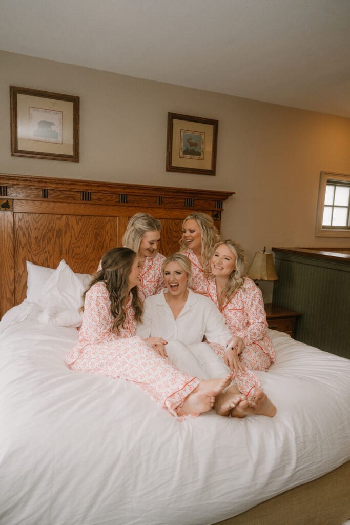 bride with bridesmaids in matching pajamas candid moment