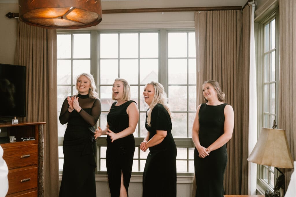 bridesmaids candid reaction when seeing the bride in her dress