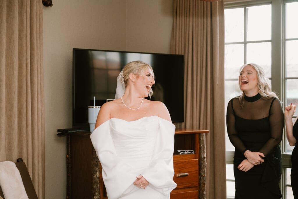 bridesmaids candid reaction when seeing the bride in her dress