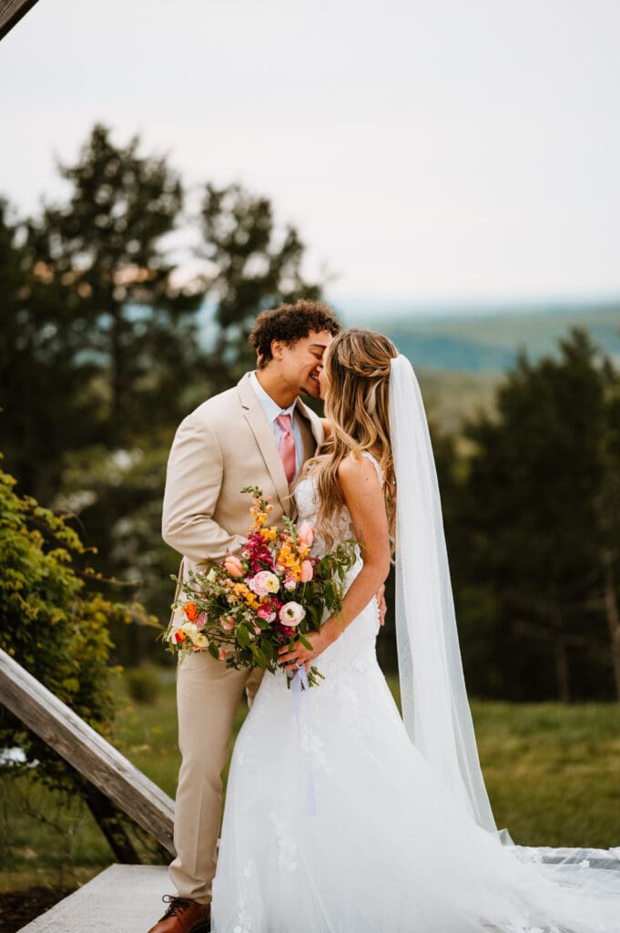 bride and groom kissing at wedding atrium branson