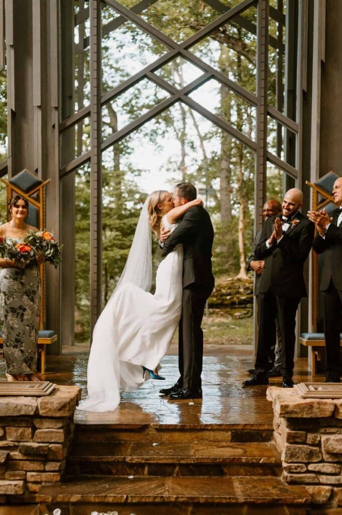 wedding couple first kiss at thorncrown chapel