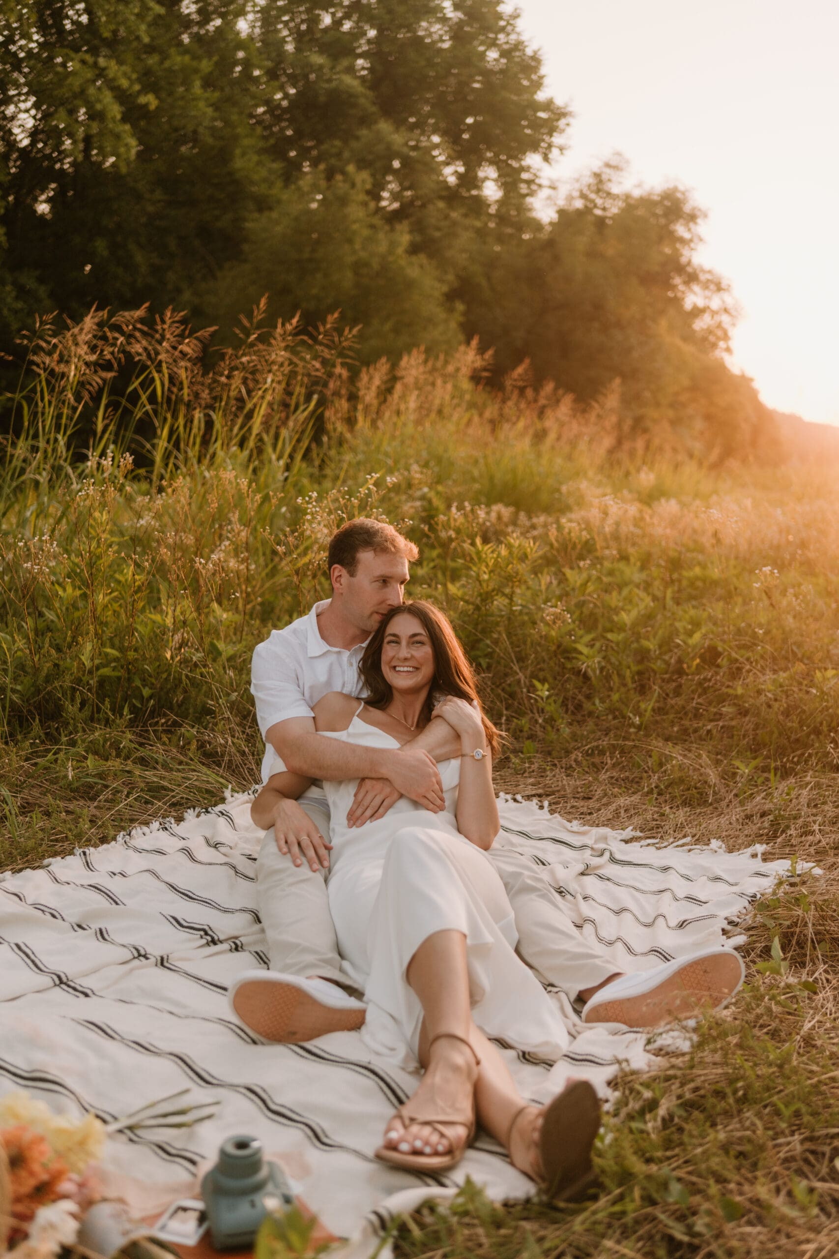 elopement couple cuddling on blanket at table rock lake
