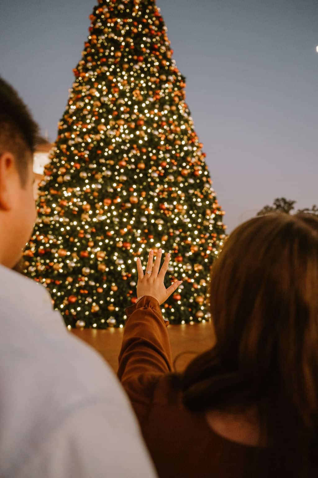 engagement ring in front of christmas tree during surprise proposal in branson missouri
