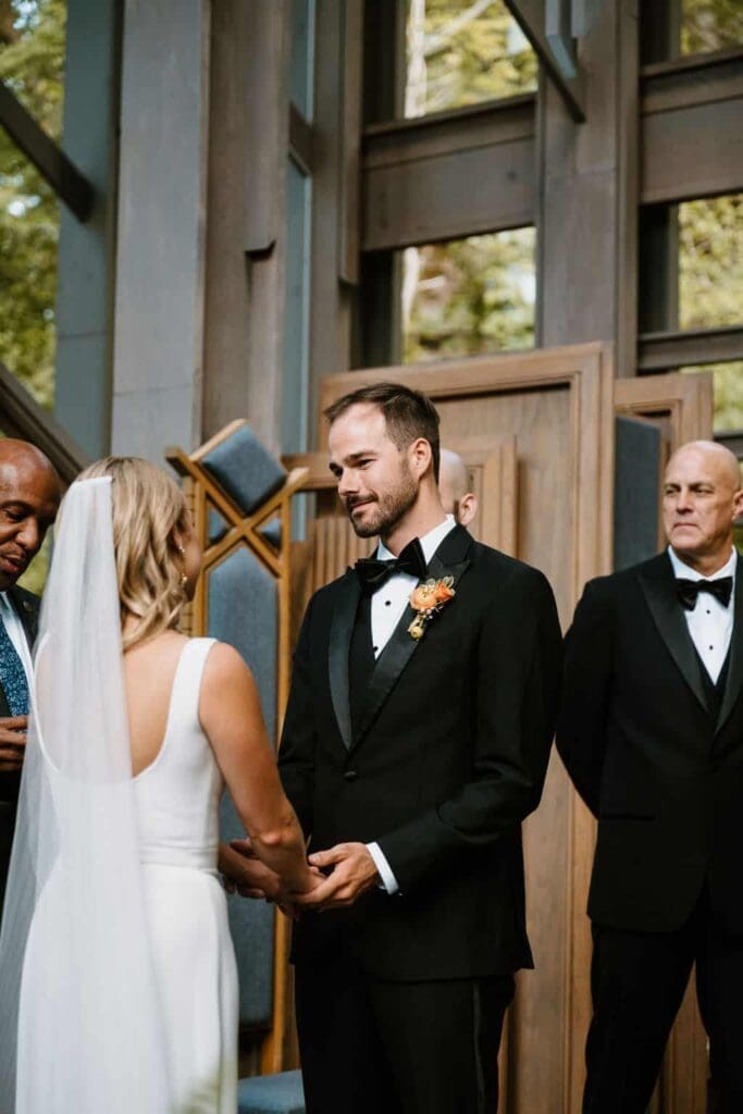 wedding couple during ceremony at thorncrown chapel 