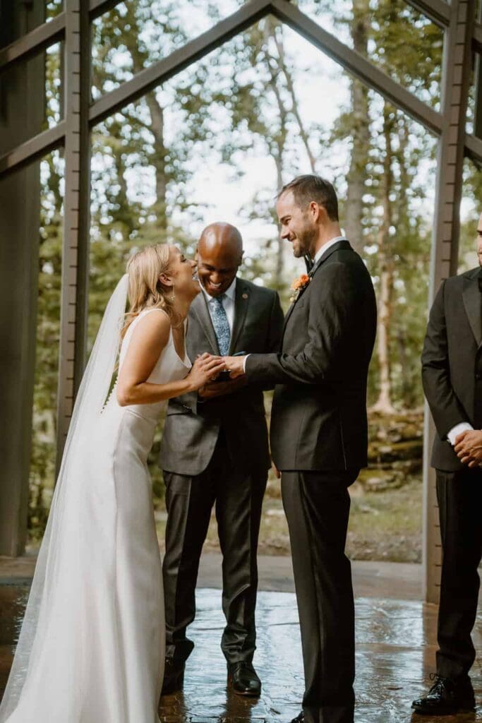 wedding couple during ceremony at thorncrown chapel 