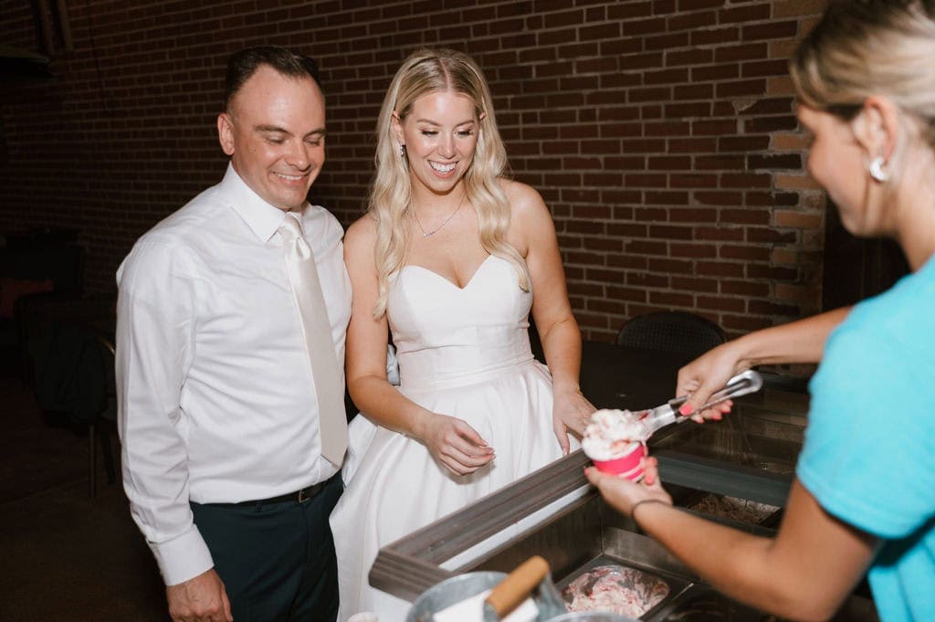 bride and groom at wedding reception getting gelato in stl mo