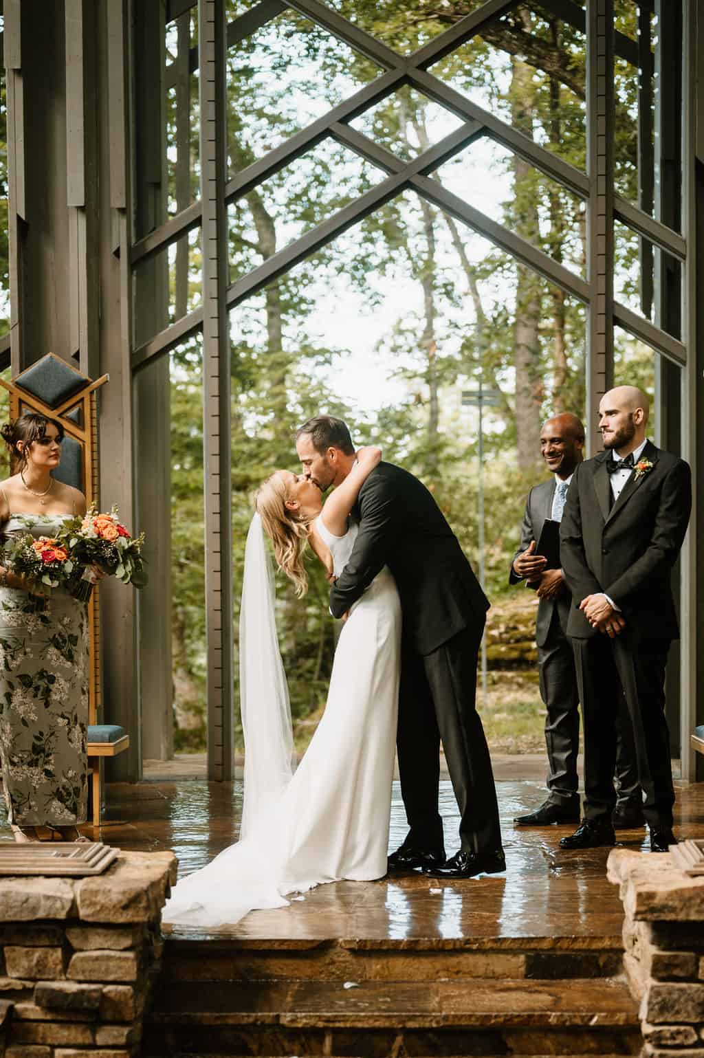 bride and groom kiss at thorncrown chapel wedding
