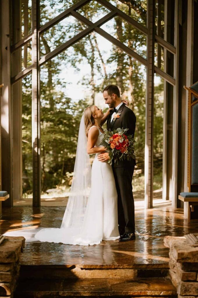 wedding couple during ceremony at thorncrown chapel 