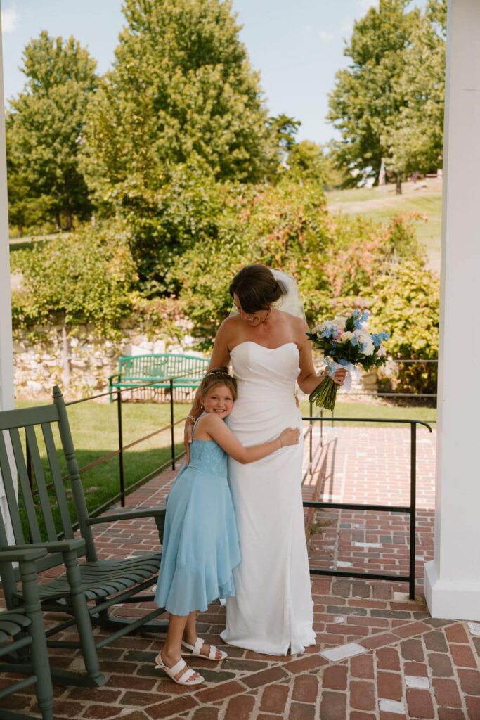 young daughter hugging mom bride at big cedar