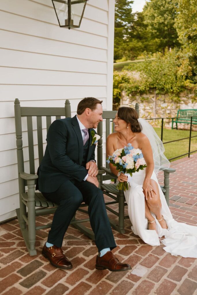 bride and groom smiling in rocking chairs