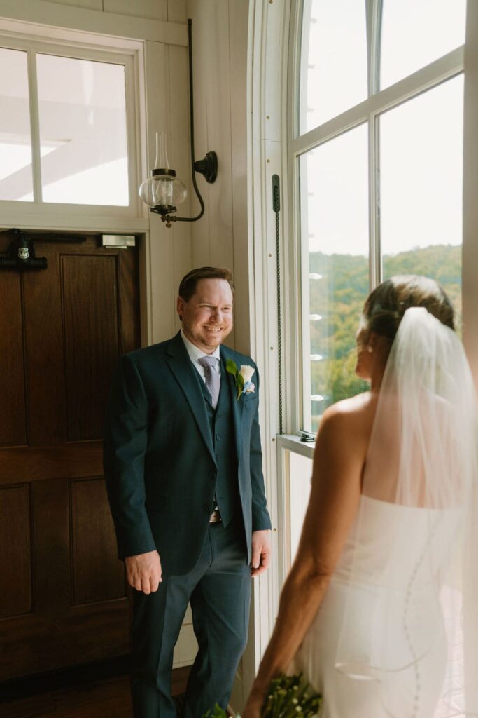 groom smiling in garden chapel
